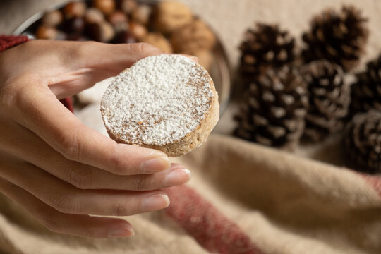 Hand holding a traditional Spanish polvoron