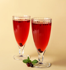 Glasses with healthy cranberry juice on color background