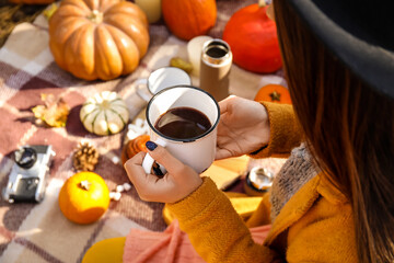 Fototapeta premium Young woman having romantic picnic on autumn day