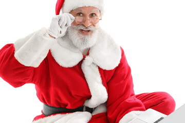 Santa Claus with modern laptop on white background