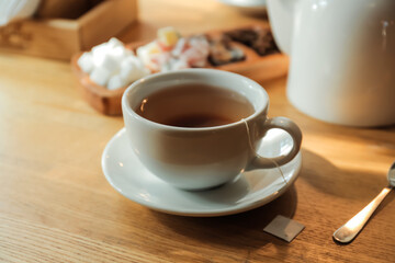 Cup of hot tea on table in cafe, closeup