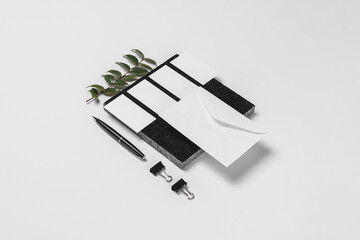 Branding and stationery mockup for branding projects, with elements of foliage on granite, paper clips, pen,A4 envelope, letter envelope, business card, notepad, notebook and letterhead.