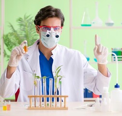 Young biotechnology scientist chemist working in lab