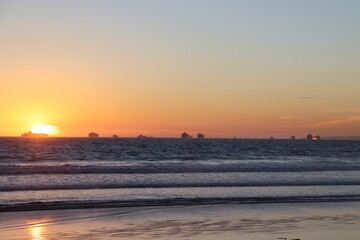 Fototapeta na wymiar Container ships waiting off Long Beach Port at sunset in 2021 shipping crisis
