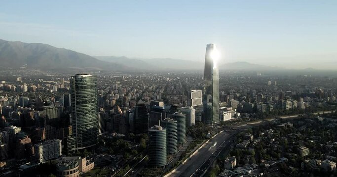 Panoramic aerial orbit of the city of Santiago with its buildings and mountains in the background