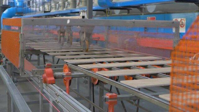 Ceramic tile manufacturing plant. Belt conveyor system line at heavy plant