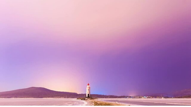 Tokarevsky lighthouse in Vladivostok. Time Laps. A picturesque lighthouse against the background of the starry sky. The Milky Way is moving around a beautiful old lighthouse.