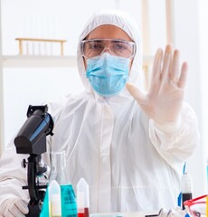 Young chemist student working in lab on chemicals