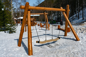 Childrens swing in the winter in the national park.