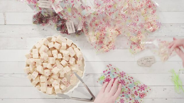 Flat lay. Step by step. Packaging homemade candy cane fudge into small gift bags.