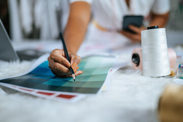 Close up hand of young designer with color chart
