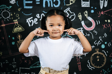 Portrait lovely girl front of education blackboard in background