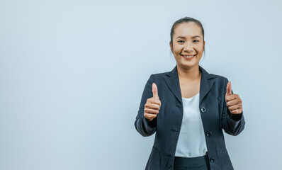 Portrait of Asian woman with two thumbs up sign gesture, isolated on background with copy space...