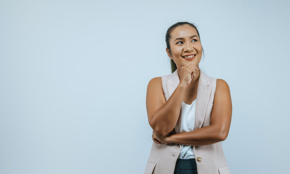 Portrait of smiling Asian woman 30s in casual clothes looking aside put hand prop up on chin isolated on wall background in studio. Mock up copy space.