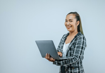 Portrait of Successful Aisan businesswoman glasses holding laptop and looking at camera on isolated background. Success and SME business concept.