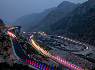 light trails  on the zigzag road in the mountains, long exposure of road with light trails, FORT...