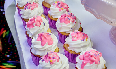 cupcake with pink frosting and sprinkles