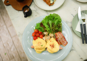 Breakfast Eggs Benedict toasted English muffins. Delicious breakfast with eggs Benedict