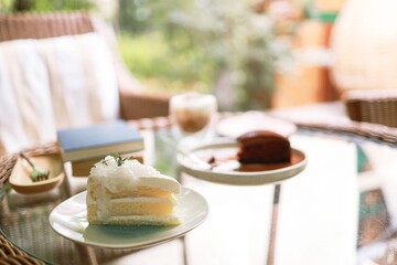 Coconut Cake and Coffee in a cafe on the blur background. traditional dessert Sliced of delicious coconut layer cake