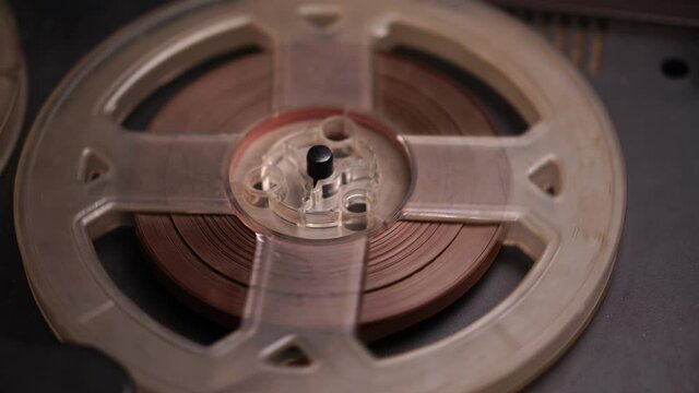 Reel-to-reel Studio Tape Spinning on Magnetophon Recorder, Close Up. Vintage Audio Media From 1960s and 1970s, Full Frame