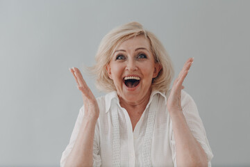 Concept affordable dentures implants. Elderly caucasian old aged woman portrait gray haired smiling...