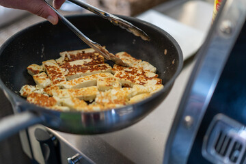 Cooking halloumi on a BBQ at home 