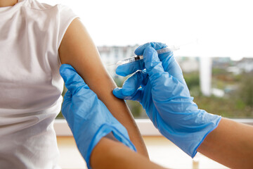 Doctor vaccinating little child in modern clinic