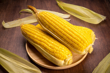 Boiled sweet corn ready to serve  in wooden background, Corn on a wooden table background.