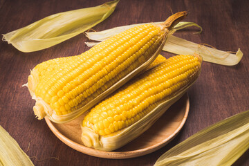 Boiled sweet corn ready to serve  in wooden background, Corn on a wooden table background.