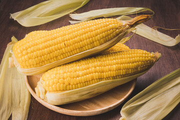 Boiled sweet corn ready to serve  in wooden background, Corn on a wooden table background.