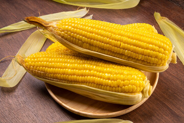 Boiled sweet corn ready to serve  in wooden background, Corn on a wooden table background.