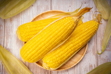 Boiled sweet corn ready to serve  in wooden background, Corn on a wooden table background.