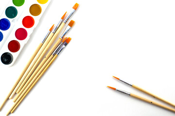 Fototapeta premium watercolor paints and brushes on a white background 