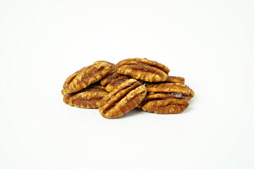 A pile of salty pecans isolated on white background. Close up of peeled pecans. 