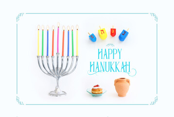 Religion image of jewish holiday Hanukkah background with menorah (traditional candelabra), doughnut and candles over white background