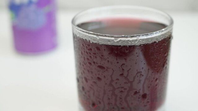 Shooting with a Glass with Cold Sweet Acidulated and Refreshing Grapefruit Drink in a Very Hot Day.
