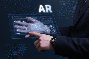 Business, Technology, Internet and network concept. Financial Graph. Stock Market chart. Young businessman working on a virtual screen of the future and sees the inscription: AR