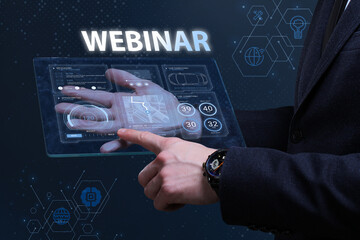 Business, Technology, Internet and network concept. Financial Graph. Stock Market chart. Young businessman working on a virtual screen of the future and sees the inscription: Webinar