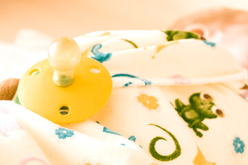 baby pacifier close-up on a baby wrapped in a blanket