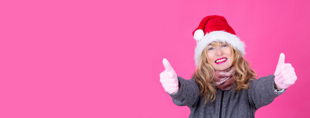 woman in santa claus cap doing ok with finger