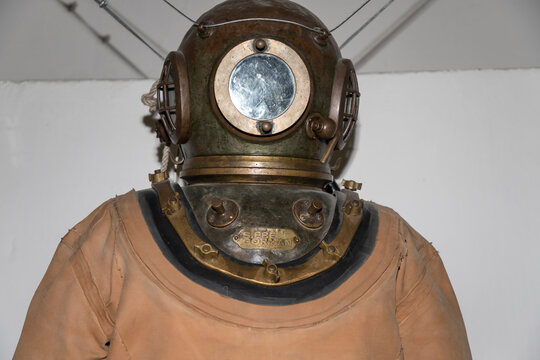 Close-up of vintage diving helmet and suit made by Siebe Gorman & Company