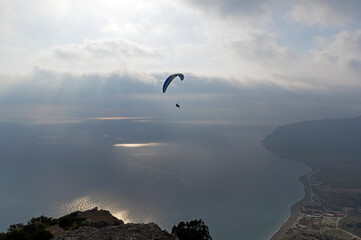 Paraglider high in the sky over the Black Sea coast. Crimea.