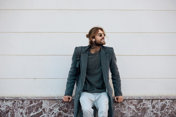 Obraz premium Caucasian stylish man on white wall background