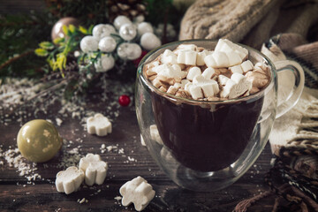 Winter concept. Hot chocolate cacao drink with marshmallows on a wooden table.