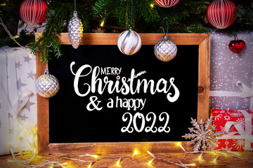 Fototapeta na wymiar Chalkboard, Tree, Gift, Fairy Lights, Merry Christmas And Happy 2022