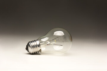 Clear glass incandescent filament bulb, analog technology