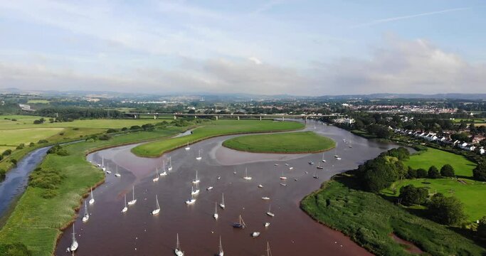 Aerial rising view over the River Exe from Topsham looking towards Exeter on a sunny day