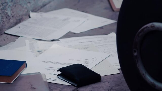 Forensic investigator found wallet on ground, collecting crime evidence, closeup shot