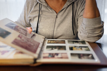 Old woman looking at family photo album