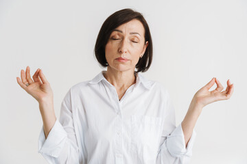 European mature woman meditating with her eyes closed